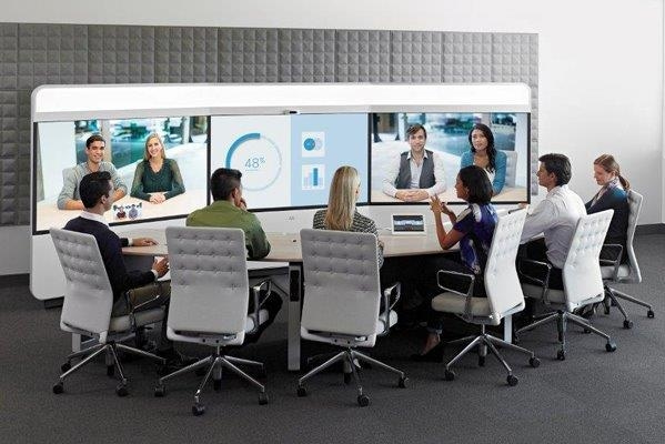 Office setting with people in a video conference meeting.