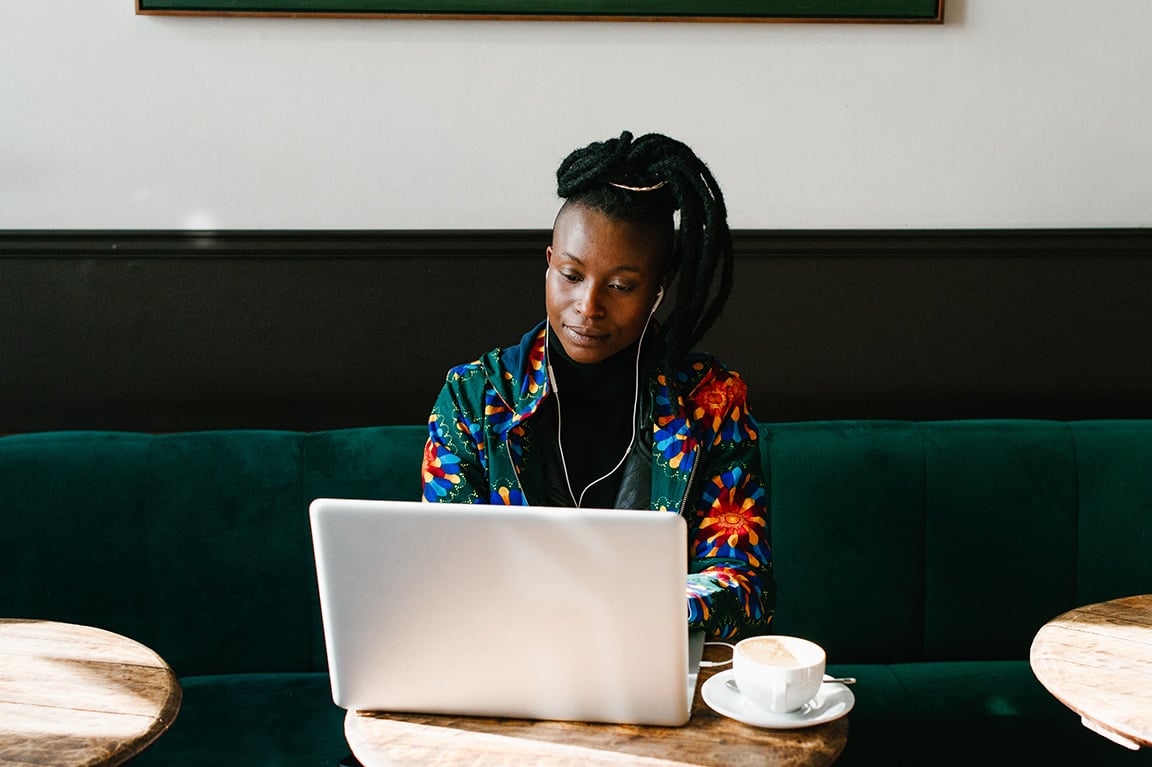Focused woman on laptop with coffee